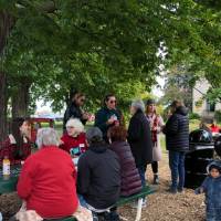 People talking after apple picking event